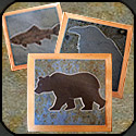 Stone mosaic trivets in wooden frames.